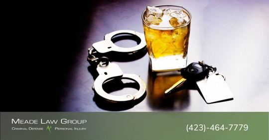 Alcoholic drink near handcuffs and car keys